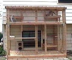 a bird cage sitting on top of a wooden stand in front of a white house