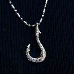 This 925 sterling silver fishhook pendant features our original Manaiakalani motif inspired by traditional Hawaiian jewelry. The engraving of the scroll was done entirely by hand. Hawaii’s fish hook necklace, commonly known as Makau, is a symbol of energy, strength, and good luck. Our fish hook motif is perfect for those that love the water, as it shows a deep love and respect for our oceans. Mānaiakalani is a constellation which translates to "The Chief's Fishline". It refers to the fishhook of Demi God, Fish Hook Necklace, Hook Necklace, Hawaiian Jewelry, Tactical Clothing, Hook Design, Deep Love, Love And Respect, Unique Pendant