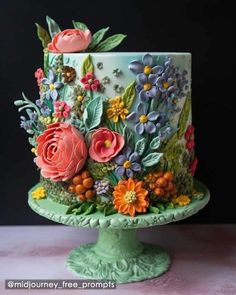 a colorful cake decorated with flowers and leaves