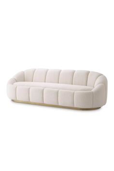 a white couch sitting on top of a wooden floor