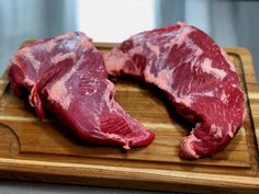 two pieces of raw meat on a cutting board