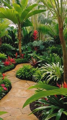 a garden filled with lots of green plants and lush greenery next to a stone walkway