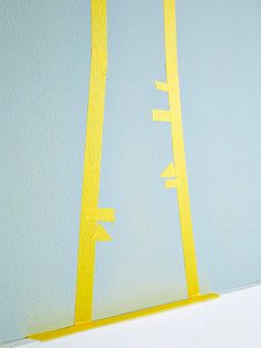 a white shelf with yellow tape on it