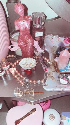 a table topped with lots of different types of cosmetics and other things on top of it