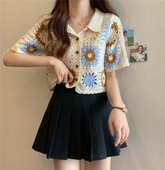 a young woman wearing a crochet shirt and black pleated miniskirt