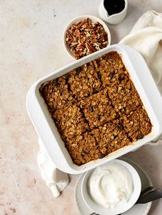 an oatmeal and yogurt dessert in a white dish on a table