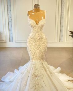 a wedding dress on display in front of a mannequins headdress