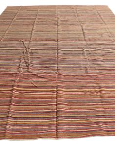 a multicolored striped rug on a white background