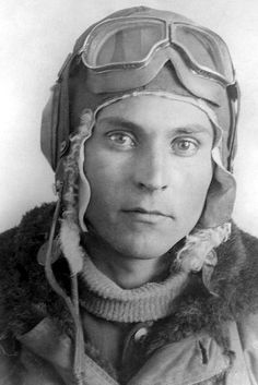 an old black and white photo of a man with goggles on