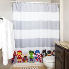 a bathroom with a striped shower curtain and toys on the floor