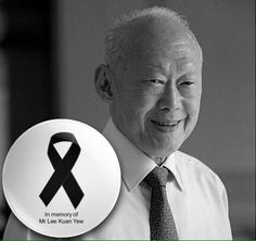 an old man holding up a black and white photo with a ribbon on it that says in memory of mr lee kuan ye