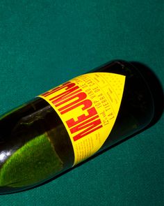 a bottle of wine sitting on top of a green table