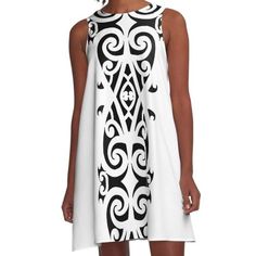 a woman wearing a black and white dress with an intricate design on the front,