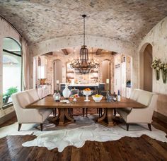 the dining room table is surrounded by two chairs and a cowhide rug on the floor