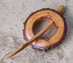 a wooden spoon rests on top of a piece of wood