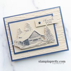 a handmade christmas card with a house and trees