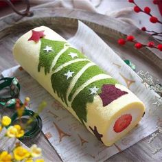 a rolled up christmas tree cake sitting on top of a paper towel