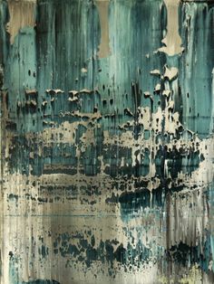 an abstract painting with blue and white paint on the side of a metal sheet that is peeling