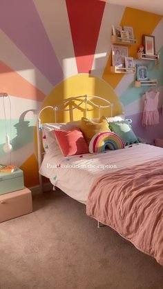 a bedroom decorated in pastel colors with pink, yellow, and green accents on the walls