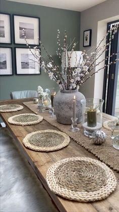 a dining room table with placemats and plates on it