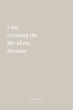 the quote i am creating the life of my dreams is written in white on a gray background