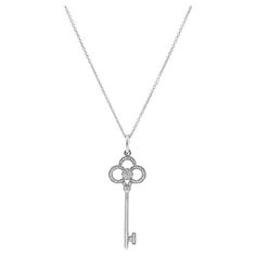 Brand: Tiffany & Co. Gender: Ladies Chain Length: 18.00 inches Pendant Length: 1.50 inches Chain width: 1.20 mm Pendant Width: 13.35 mm Total Weight: 4.48 grams  One 18K white gold single-strand diamond necklace. The metal was tested and determined to be 18K white gold. Engraved with "750". The "Tiffany & Co." trademark (or hallmark) can also be found on the item. In excellent condition. Pre-owned. Might show minor signs of wear. Bezel Set in 18 Karat White Gold with: One (1) round brilliant cut natural diamond: Measurements: 1.40mm - 1.42mm in diameter x ~0.86mm in depth. Estimated Weight: 0.010 ct. Color: F - G Clarity: VS1 Cut: Very Good Polish: Very Good Symmetry: Very Good Pavé set in 18 Karat White Gold with: Thirty-eight (38) round brilliant cut natural diamonds: Measurements: 0.60m Simple Tiffany Necklace, Tiffany And Co Key Necklace, Tiffany Key Necklace, Tiffany Key, Tiffany And Co Necklace, Mini Crown, Tiffany Necklace, Key Pendant Necklace, Key Necklace