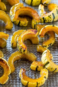 roasted squash rings on a baking sheet ready to be cooked in the oven for roasting