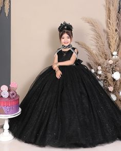 Elevate your little one's presence with our stunning black princess ball gown, perfect for birthdays, pageants, or as a luxurious flower girl dress. Designed for comfort and style, order now to enchant your girl with glamour! ----DETAILS---- > Floor Length > Round Neck with Band Collar > Sleeveless ----ITEM MATERIAL---- Upper layer of the skirt- Glitter Tulle Middle layer of the skirt- Tulle Lower layer of the skirt- Satin Bodice of the dress- Glitter Moonlight, Satin -----COLOR----- If you want Elegant Black Ball Gown For Quinceanera, Black Princess Dress For Evening, Elegant Black Princess Dress For Party, Elegant Princess Dress For Quinceanera, Black Tulle Dress For Pageants, Elegant Quinceanera Gown, Princess Evening Ball Gown Pageant Dress, Princess Style Ball Gown Pageant Dress For Evening, Black Princess Ball Gown Dress