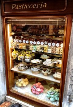 a display case filled with lots of different types of food in front of a store