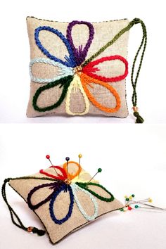 two pillows with colorful thread work on them and one is made out of fabric, the other has a tassel