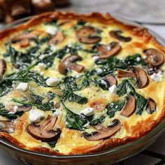 a quiche with spinach, mushrooms and cheese