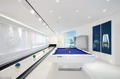 an image of a pool table in the middle of a room with white walls and flooring