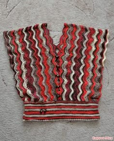 a red and white striped vest hanging on the wall