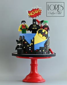 a batman cake with lego figures on top