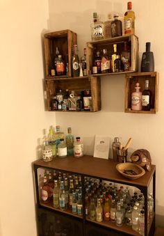 two wooden shelves filled with bottles and spices