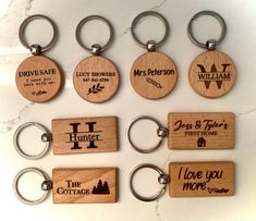 wooden keychains with engraved names on them sitting on a marble countertop in front of a white background