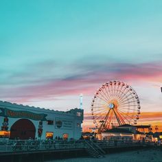 a ferris wheel sitting on top of a sandy beach