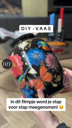 a person is holding a flowered helmet with the words diy - vas on it