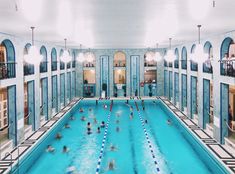 an indoor swimming pool with people in it