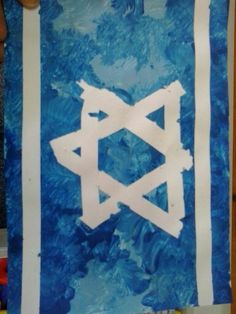 a blue and white wall hanging with the word judaism painted on it