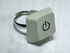 a white ring with a blue symbol on it