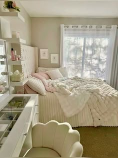 a bedroom with a bed, dressers and chair in it's center area