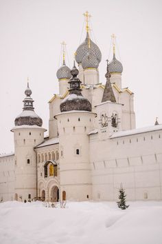 a large white building with two towers in the snow