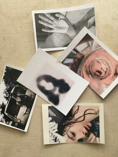 several polaroid photographs are arranged on a table with one being a woman's hand