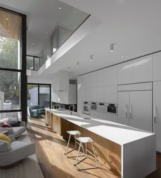 an image of a modern kitchen setting with white cabinets and counter tops in the middle