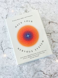 a book sitting on top of a table next to a white counter with an orange and blue circle