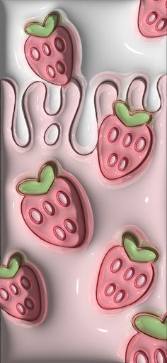 some pink and green strawberries on a white surface