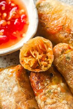 some fried food is on a plate with dipping sauce