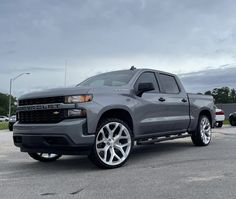 a silver truck parked in a parking lot