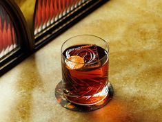 a glass filled with liquid sitting on top of a table